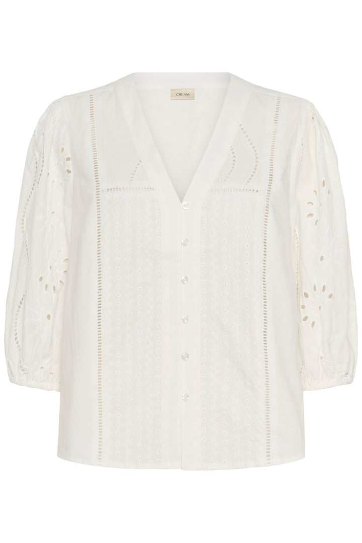 Blouse Signe avec encolure en V, détails ajourés et broderies raffinées, élégante et fluide pour un look féminin et sophistiqué.