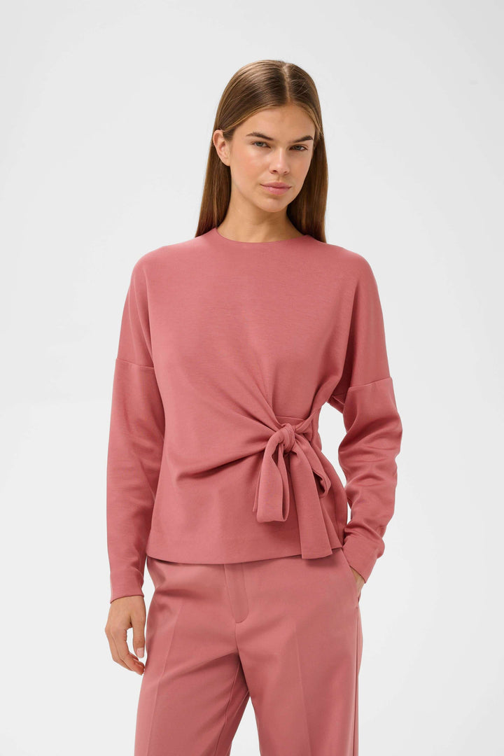 Blouse Tricent en design contemporain avec détail noué sur le côté et manches longues