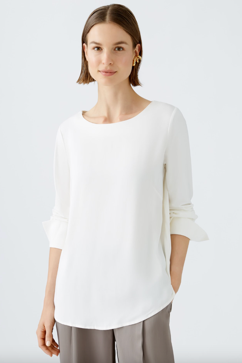Blouse blanche à col rond, manches 3/4, coupe décontractée, élégante et confortable, parfaite pour un look chic.