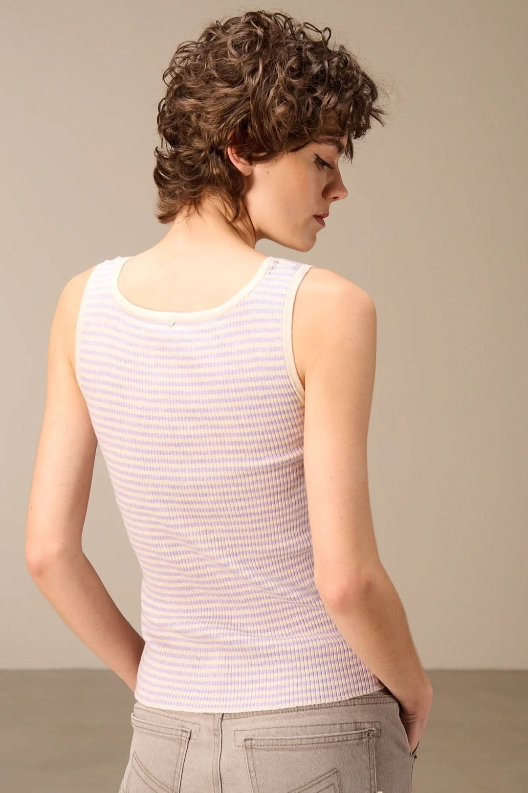 Homme portant une camisole côtelée rayée col rond, vue de dos, montrant la texture côtelée et la coupe ajustée.