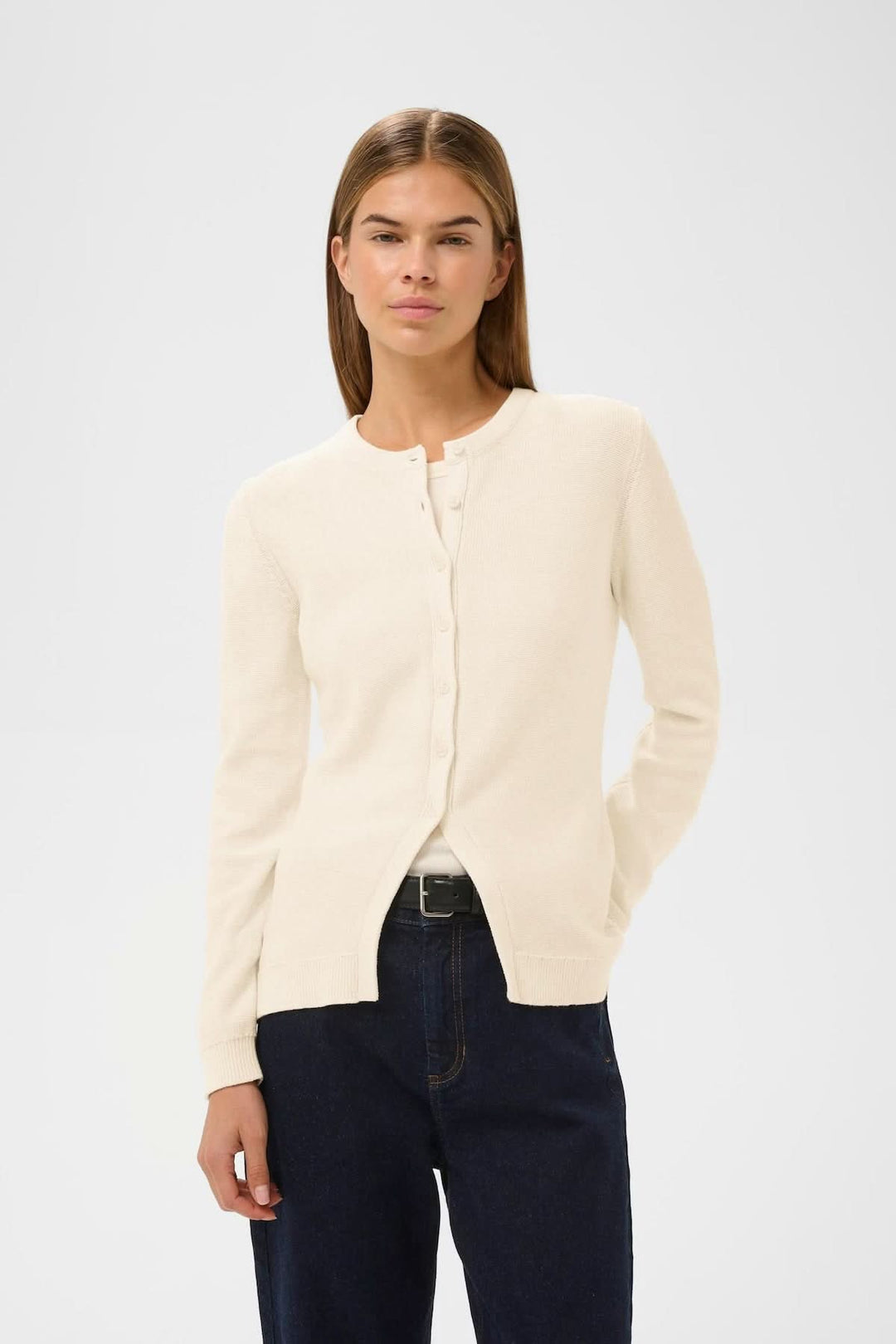 Femme portant un Cardigan en maille NAASU crème avec coupe droite et encolure arrondie, design épuré et élégant.