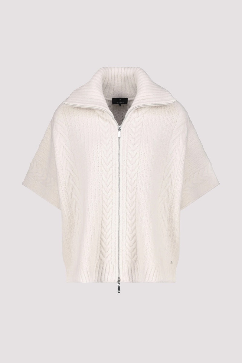 Cardigan oversize en maille torsadée blanche avec col roulé et fermeture éclair à l'avant.