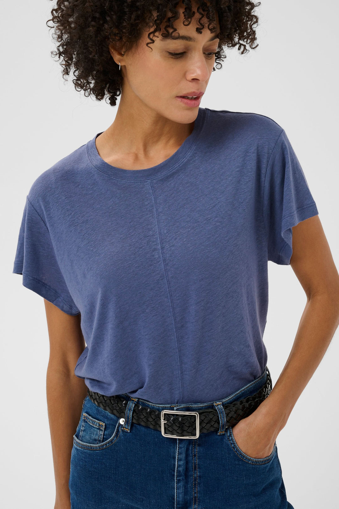 Femme portant le Chandail Anemona minimaliste et contemporain avec coupe droite ample, encolure ronde et manches courtes tombantes.