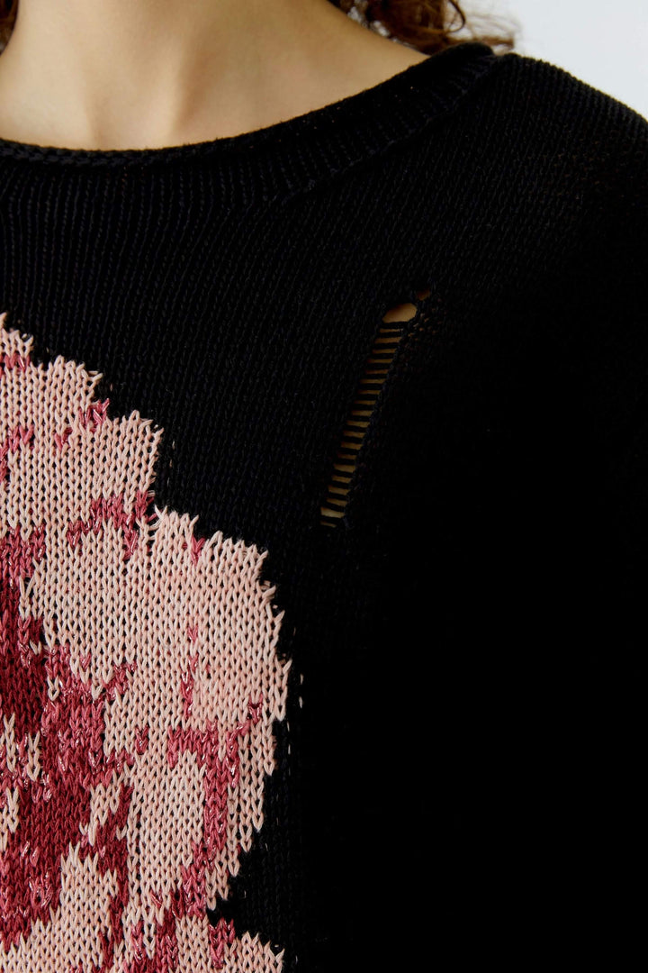 Chandail imprimé floral avec motif expressif et détails ajourés, silhouette décontractée. Idéal pour tenues du quotidien.