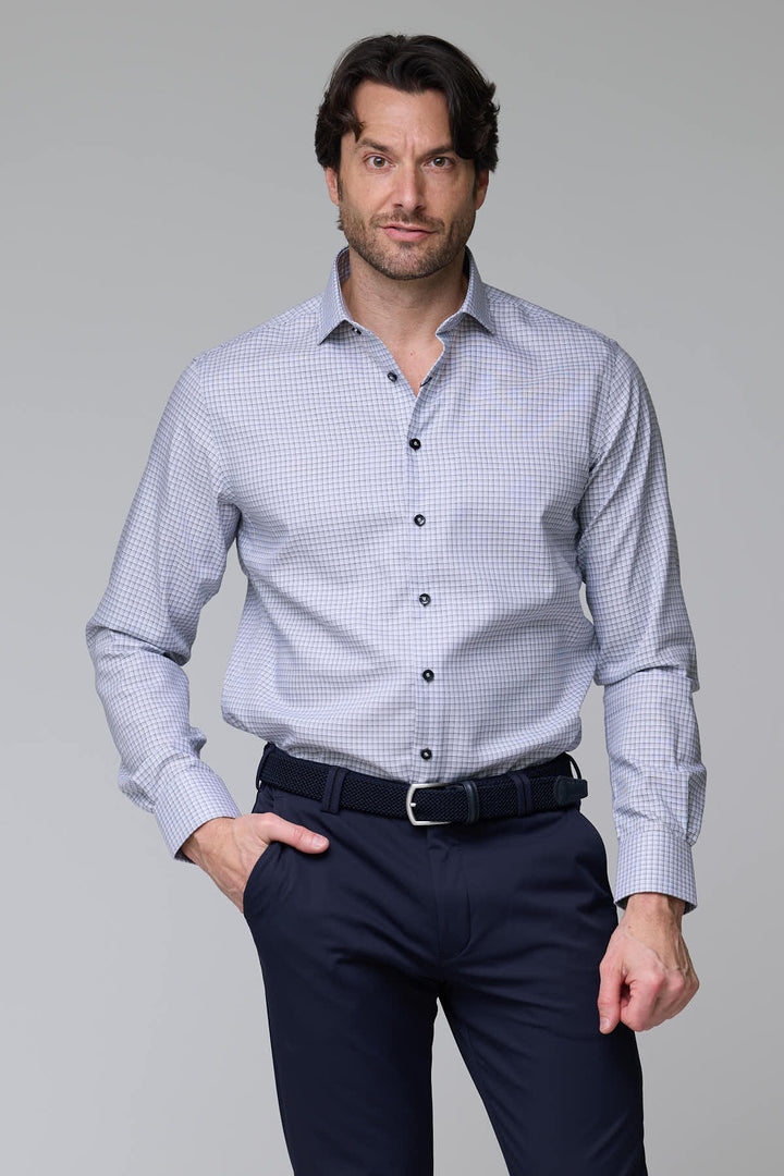 Homme portant une chemise à carreaux fins à manches longues, coupe ajustée, idéale pour un style professionnel et décontracté.