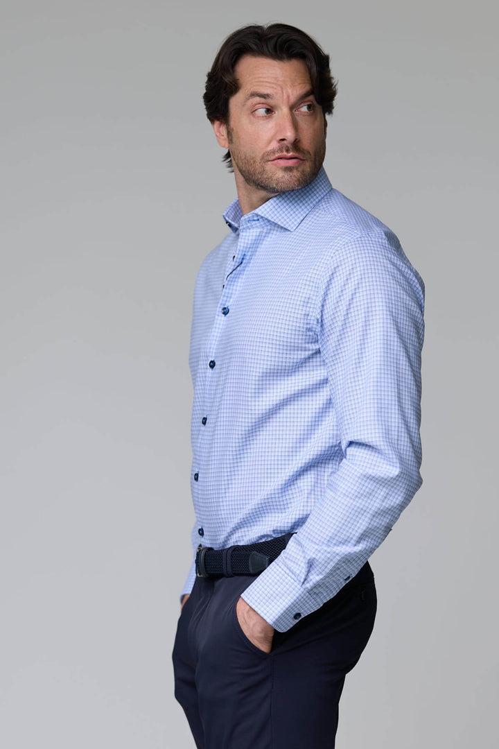 Homme portant une chemise à carreaux fins, manches longues, coupe ajustée, look professionnel, style polyvalent.