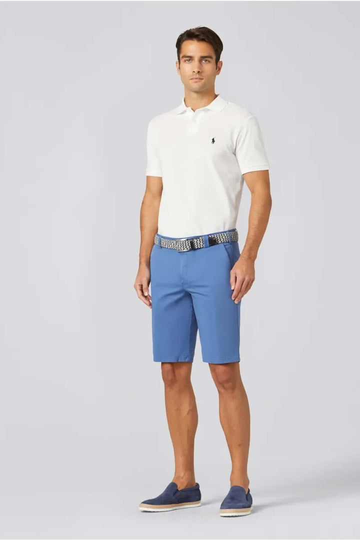 Homme portant un polo blanc et un short chino bleu, idéal pour un look estival décontracté.