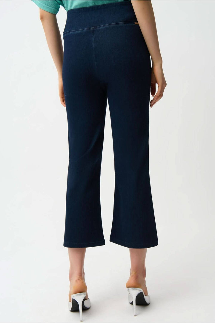 Vue arrière du denim évasé raccourci à taille haute, coupe flatteuse avec longueur raccourcie, porteur en talons blancs, sur fond blanc.