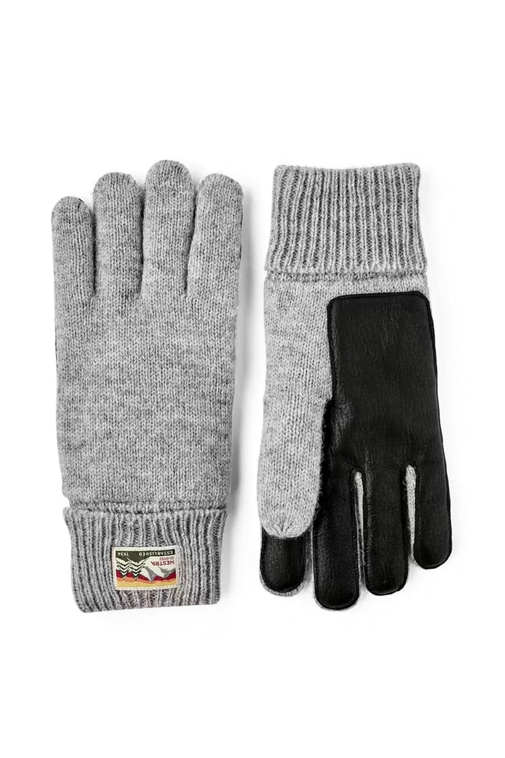 Ganst en maille gris avec poignets côtelés pour confort et chaleur, parfaits pour les journées fraîches et look quotidien.