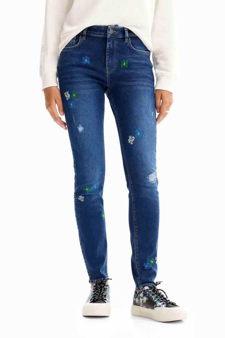 Jean skinny push-up brodé avec fleurs et déchirures, taille mi-haute, confort extra en tissu stretch.