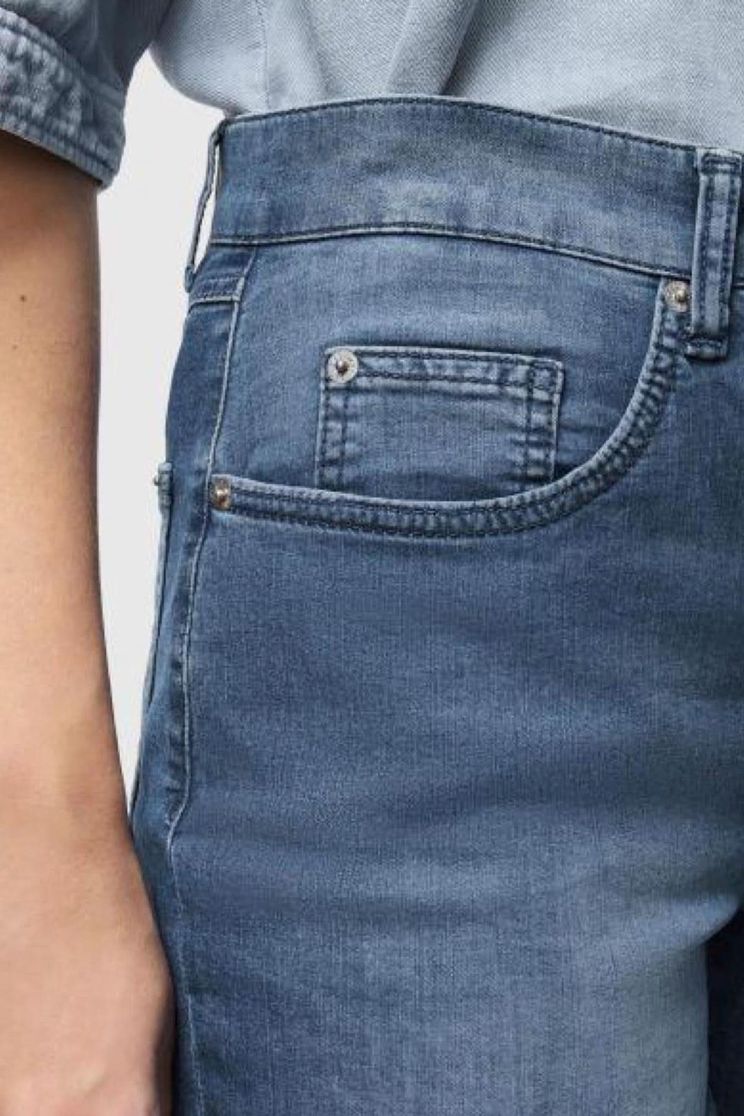 Close-up of Jeans Carol, a timeless light denim with a classic straight leg design, showcasing refined comfort.