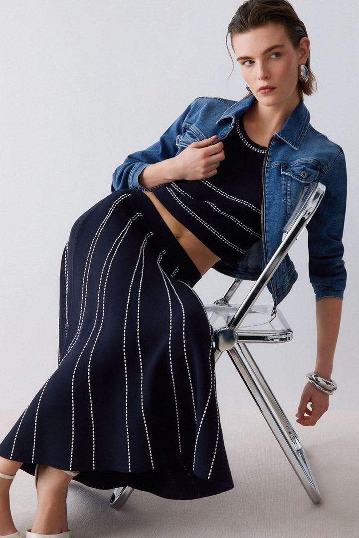 Jupe midi évasée à motif rayé portée avec veste en jean, mettant en valeur l&