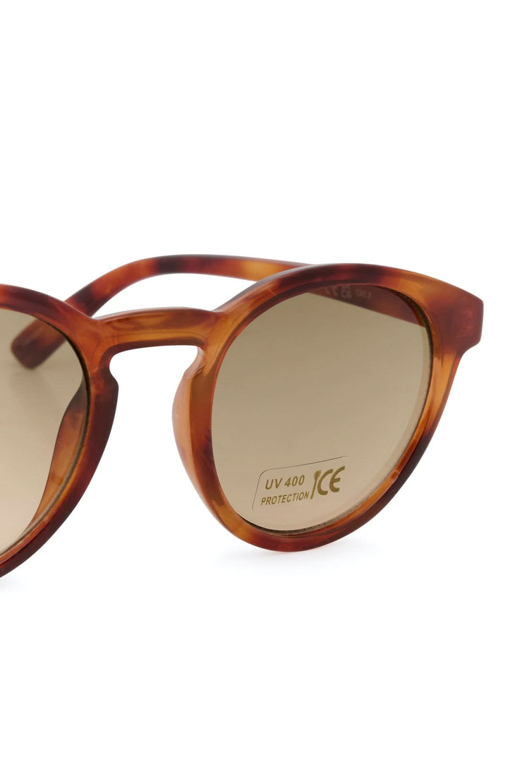 Lunette de soleil Nino en acétate écaille, verres teintés, design arrondi et élégant pour style décontracté et protection UV.