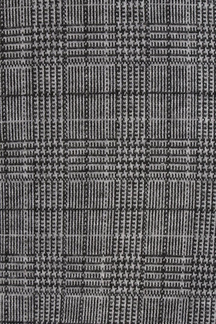 Motif à carreaux prince-de-galles en noir et gris pour pantalon élégant et intemporel.