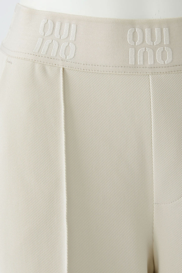 Pantalon droit à taille élastique logo avec plis marqués pour un style moderne et structuré, offrant confort au quotidien.