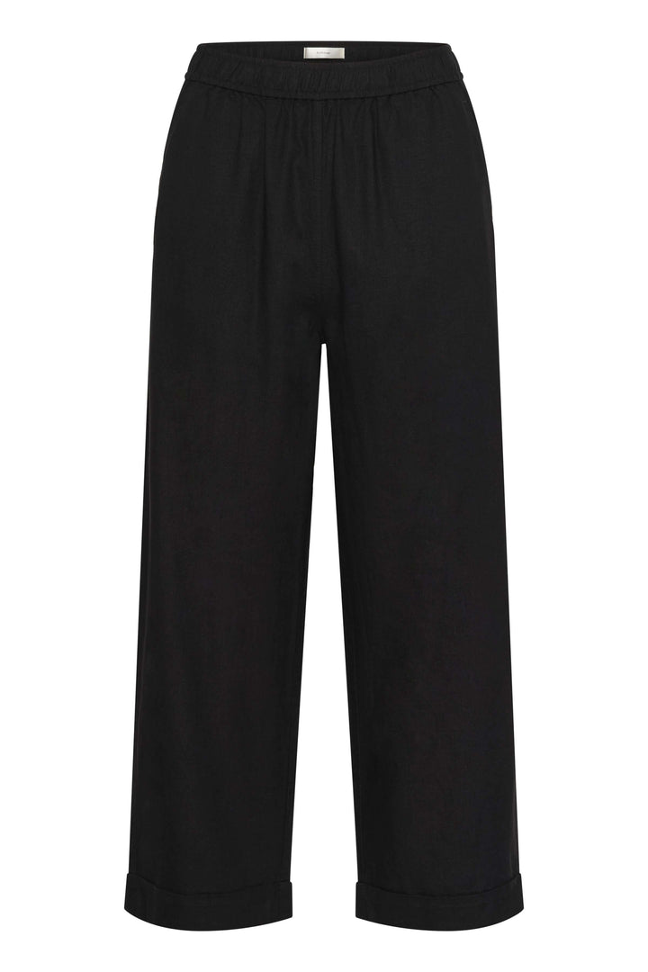 Pantalon en lin noir avec taille élastique, jambes larges et poches latérales, parfait pour confort et élégance.