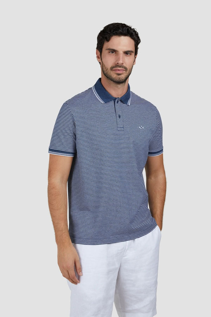 Homme portant un Polo rayé en coton piqué Jaspe, coupe classique, motif rayé bleu, broderie discrète, idéal pour l&
