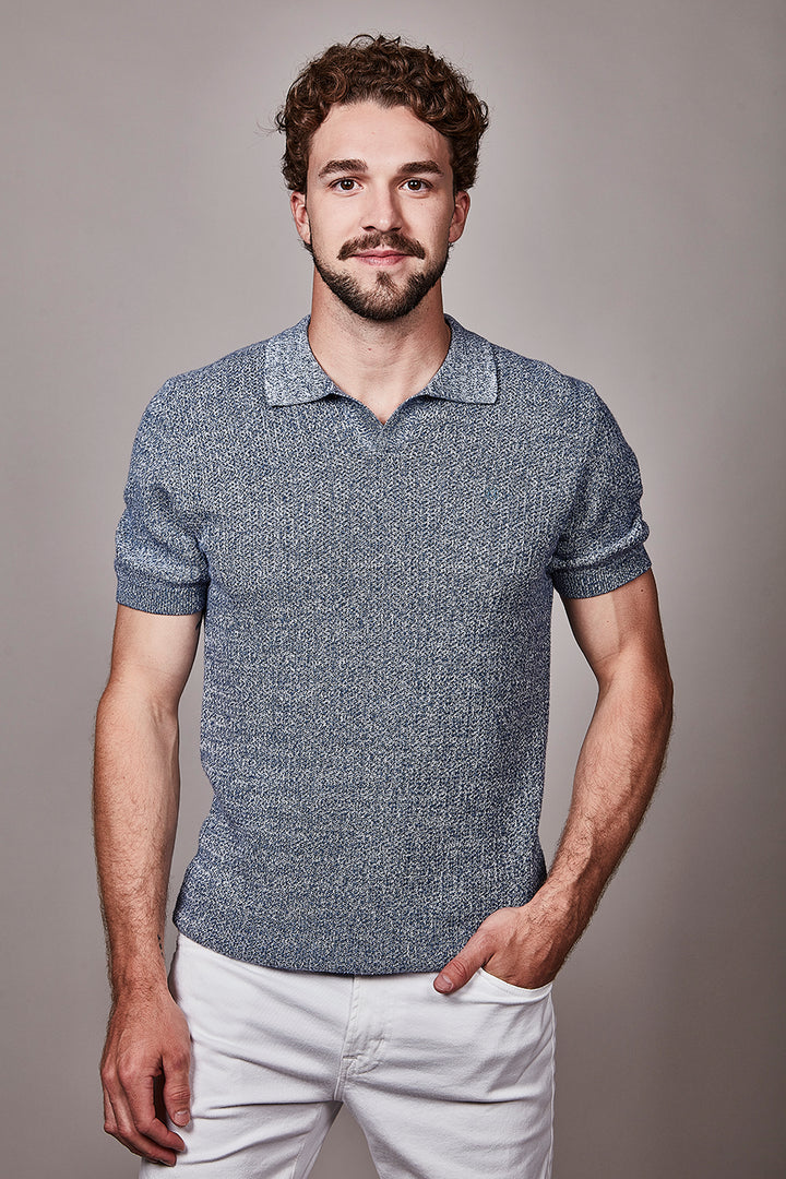 Homme portant un polo texturé à manches courtes élégant, coupe régulière et col classique, parfait pour un style quotidien soigné.
