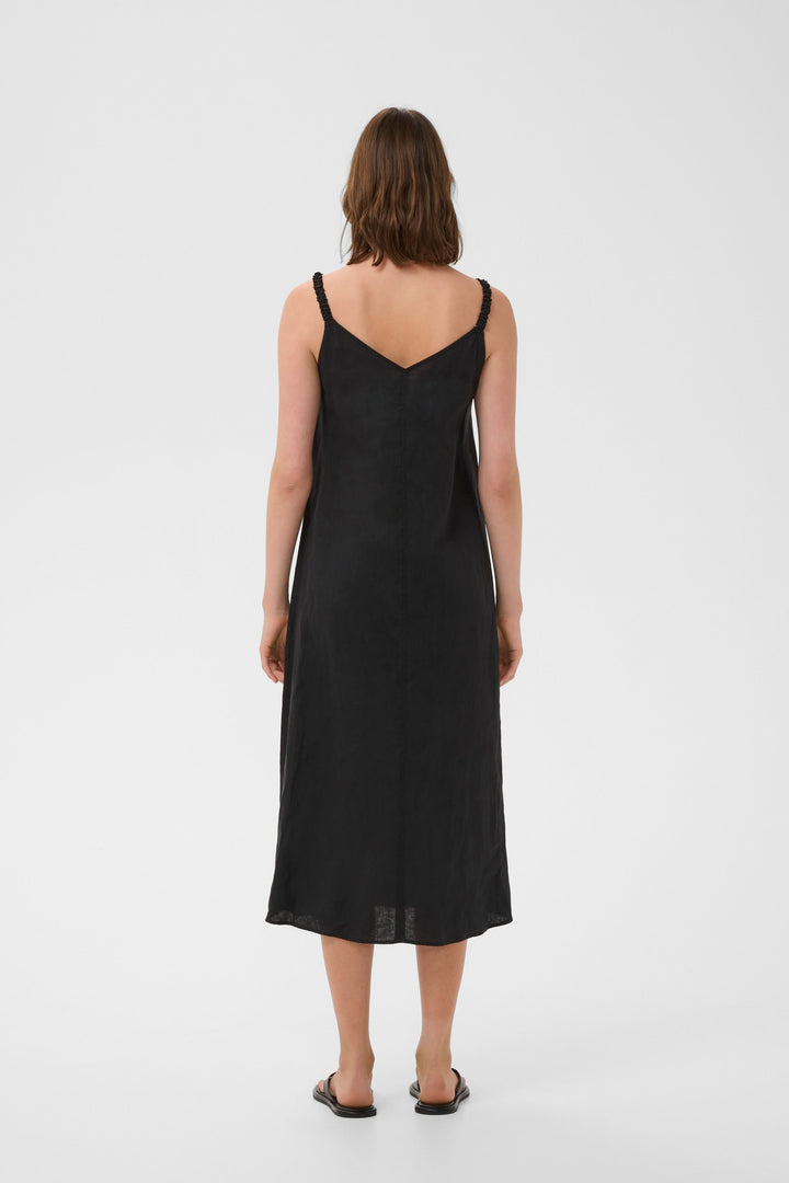 Vue arrière de la Robe Elinor midi fluide à bretelles fines en lin noir, coupe ample et encolure en V.