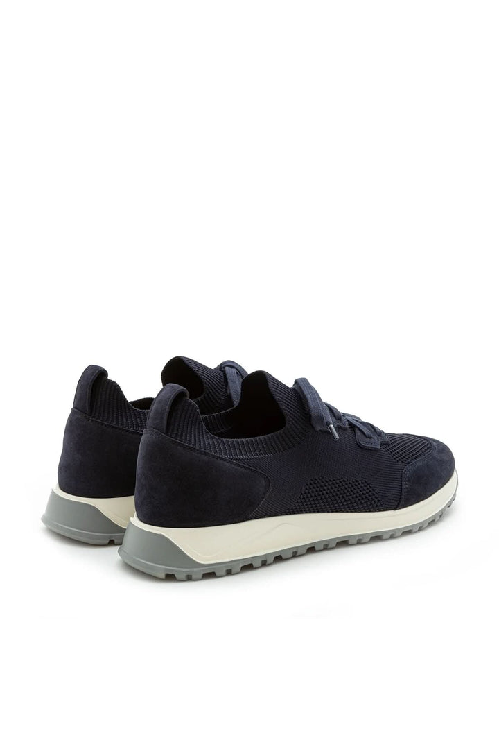 Sneaker homme cuir et tissu extensible avec semelle légère et style moderne pour un look décontracté chic.