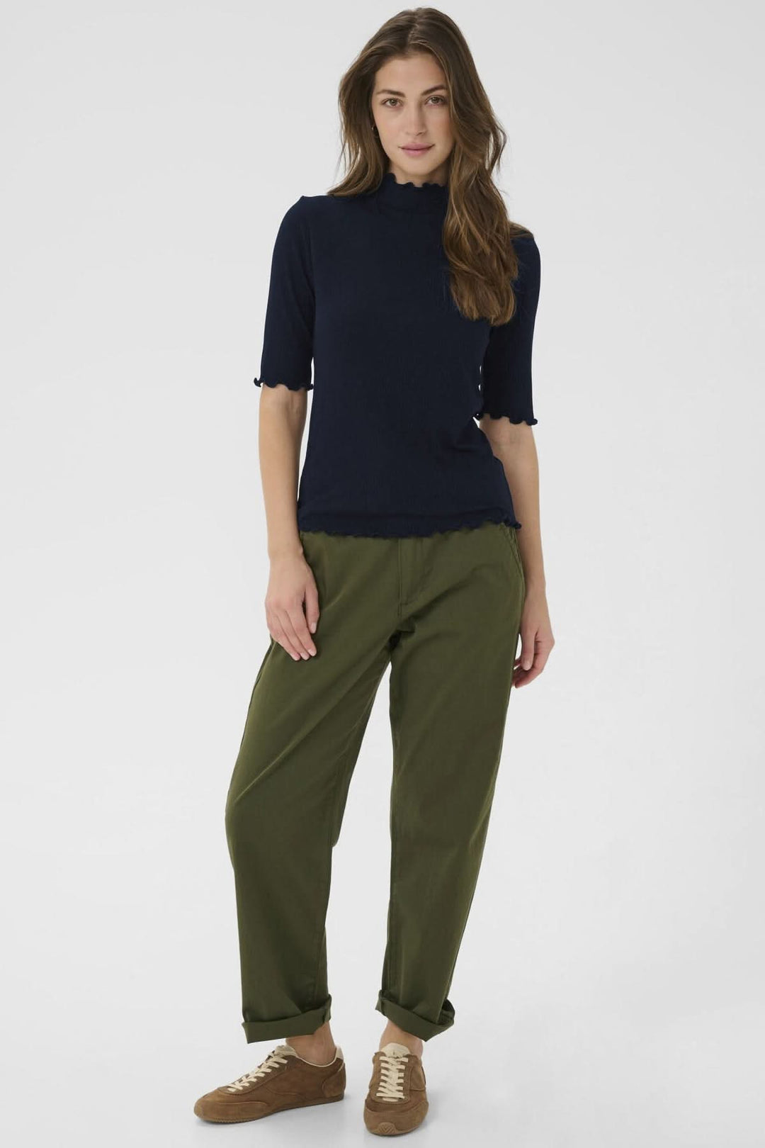 Femme portant le T-shirt Ribba à col montant festonné et manches mi-longues, coupe ajustée en maille côtelée extensible.
