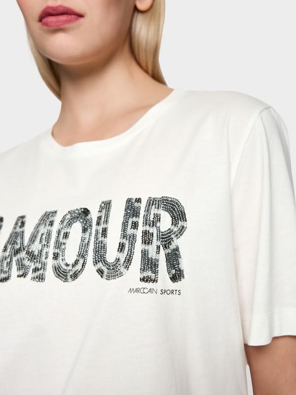T-shirt à paillettes avec slogan "Amour" en lettres scintillantes, col rond, manches courtes, en coton pour un confort optimal.