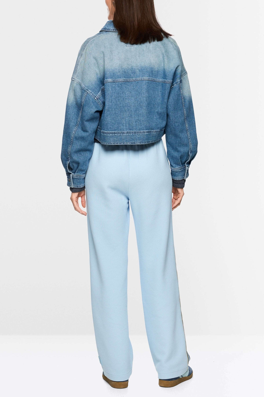 Veste courte en jean avec fermeture éclair vue arrière, coupe ample et moderne.