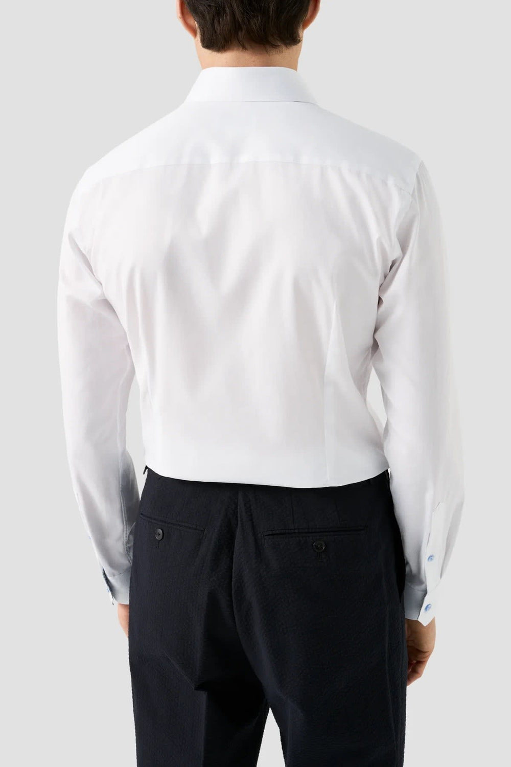 Front view of a white Eton men's dress shirt with black contrasting details - Valérie Simon