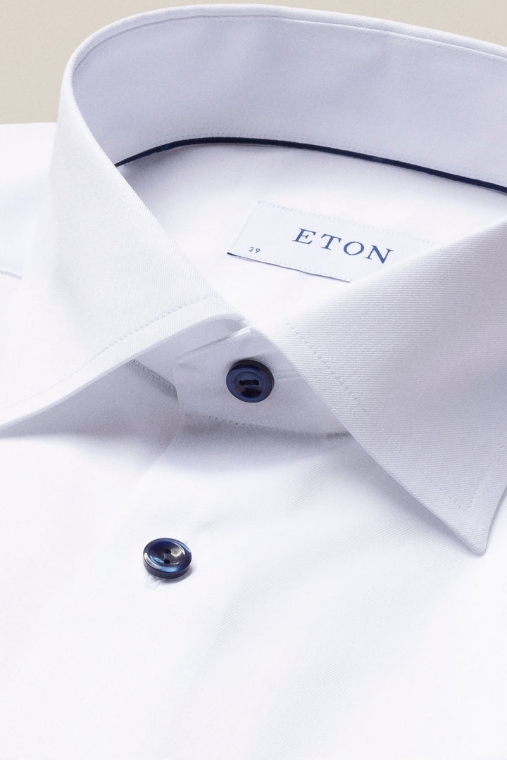 White shirt with navy buttons