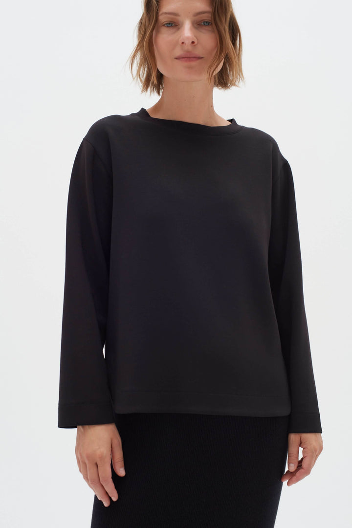 Chandail Gincent noir à manches longues avec encolure bateau, style minimaliste et coupe droite.