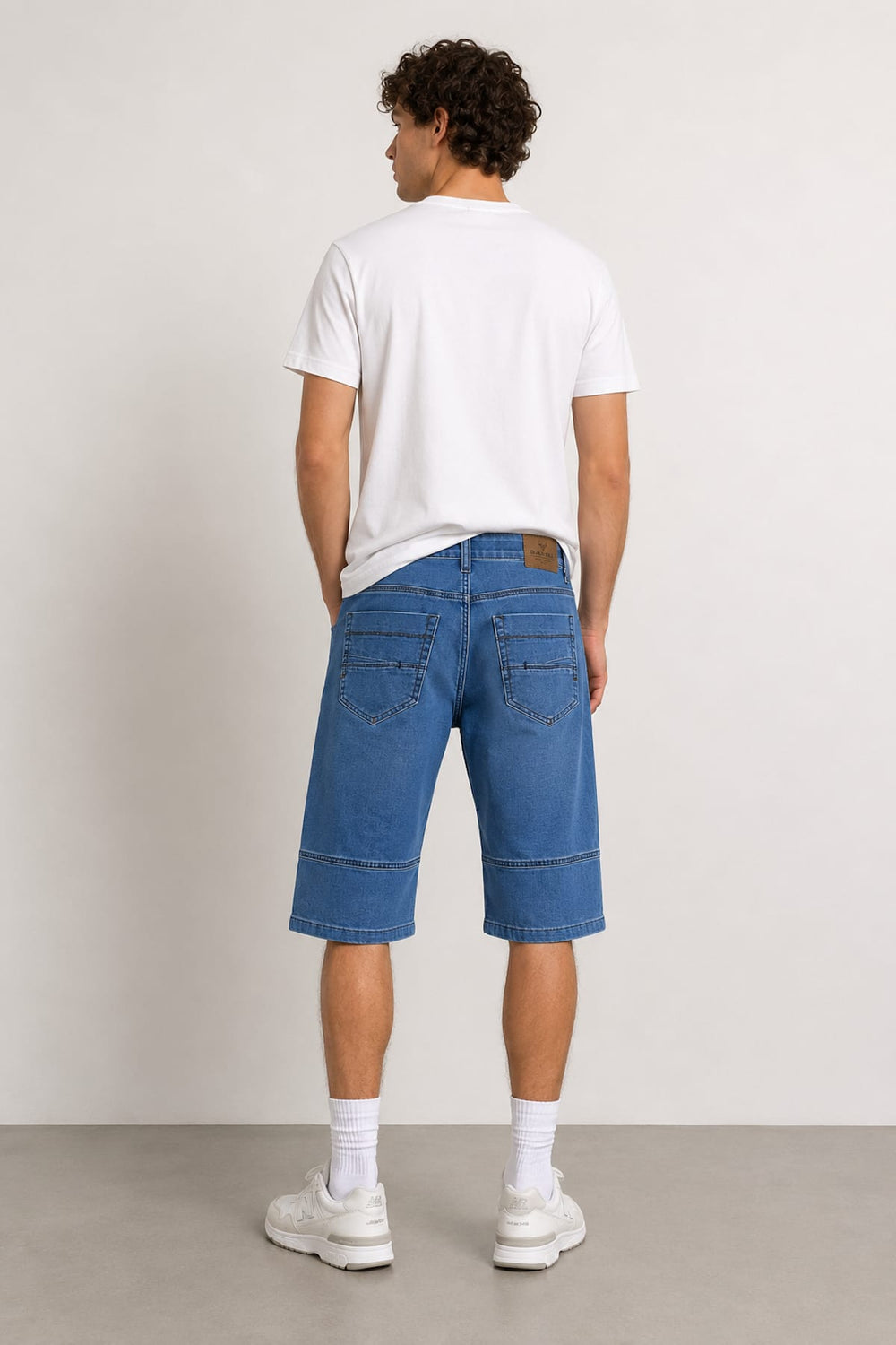 Front view of Black Bull men's blue stretch denim shorts with exposed seams - Valérie Simon