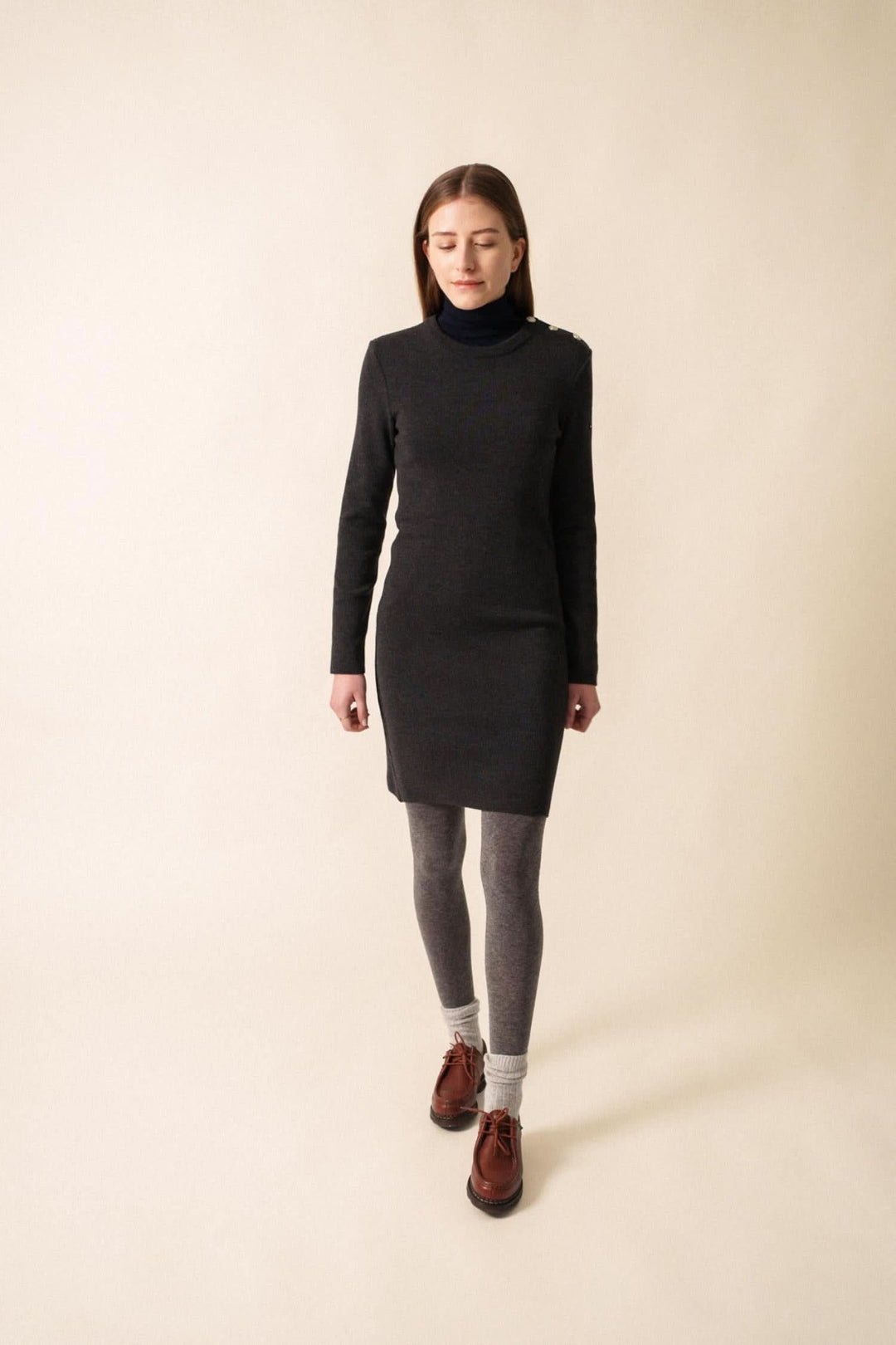 Robe Grande Maree U, coupe ajustée en laine, col rond, portée avec collants et bottines, style automnal chic.