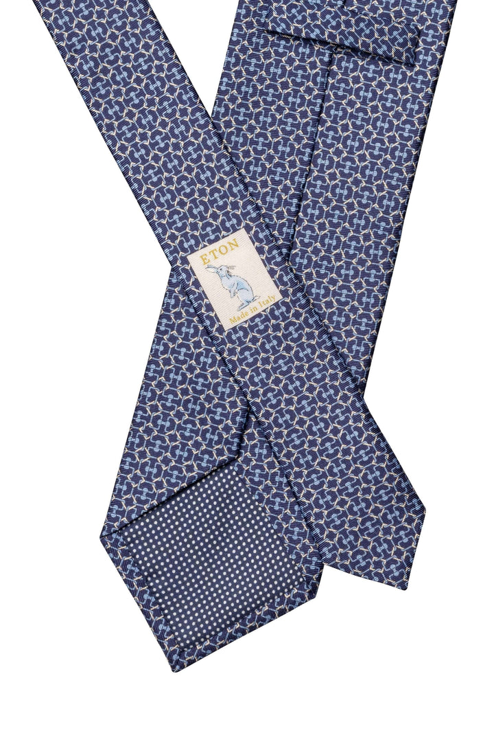 Cravate bleu à motif géométrique, ajoutant élégance moderne à un costume formel.